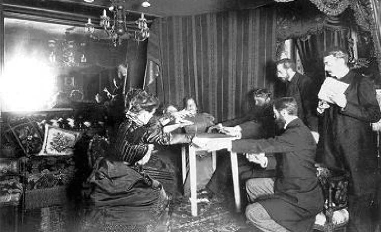 A Victorian spiritualist seance with an apparent table levitation